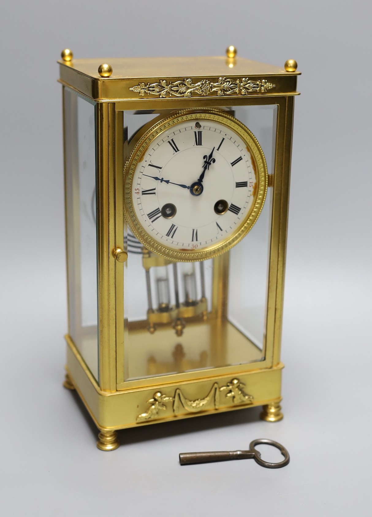 A late 19th century French four glass mantel clock, mercury pendulum and key, 26cm tall